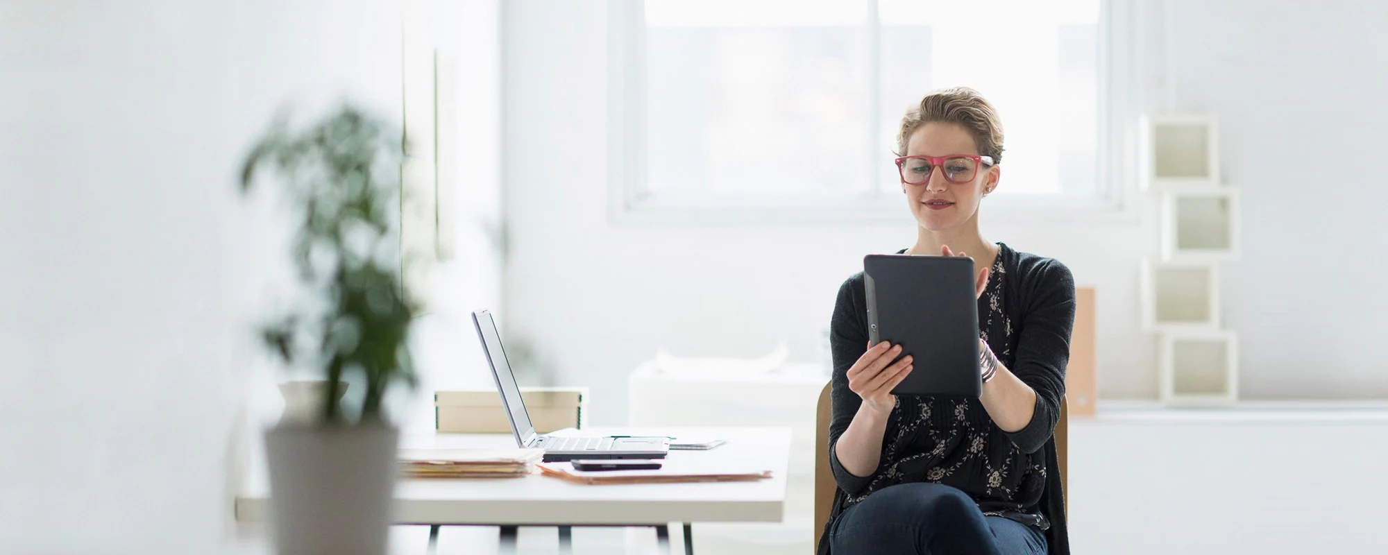 A woman reviewing her business finances on a tablet