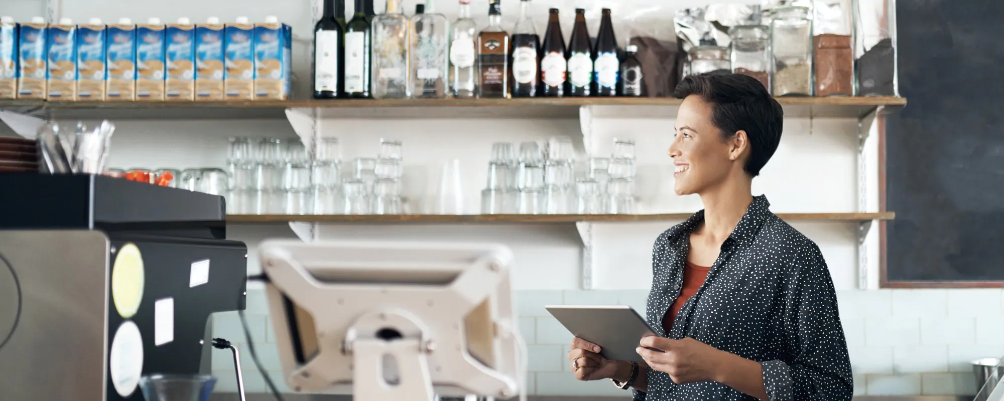 Woman reviews her business expenses on a tablet